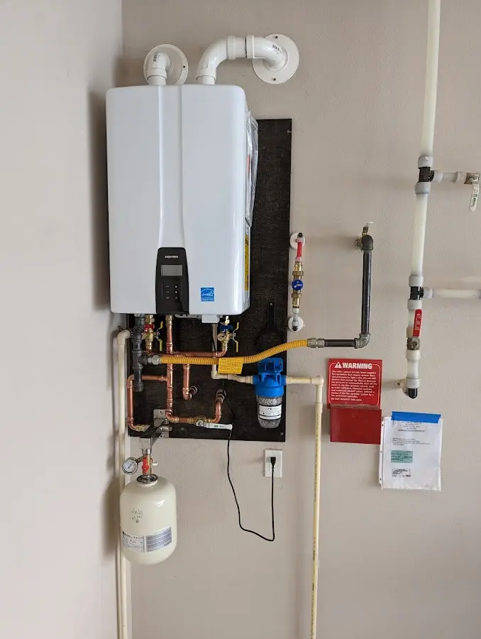 Professional plumber installing copper piping in a Park Center home